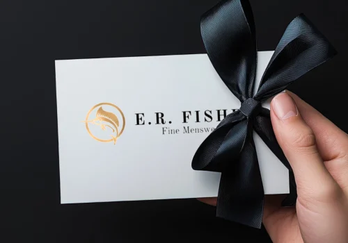 hand holding a ER Fisher Gift Card with bow