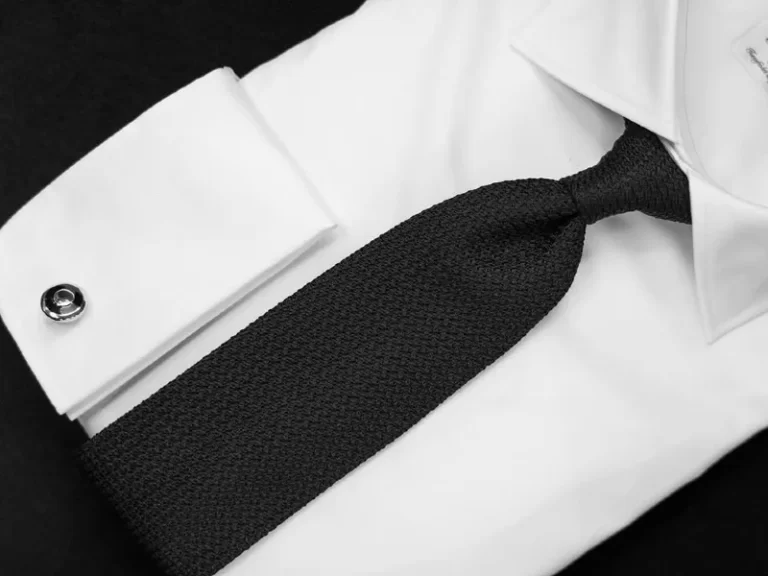 Closeup of men's formal shirt, tie and cuff links