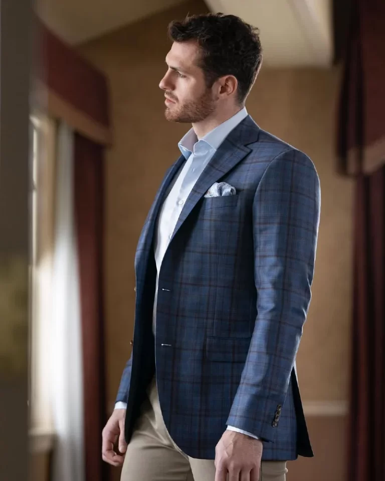 Man standing wearing tailored suit jacket with pocket square